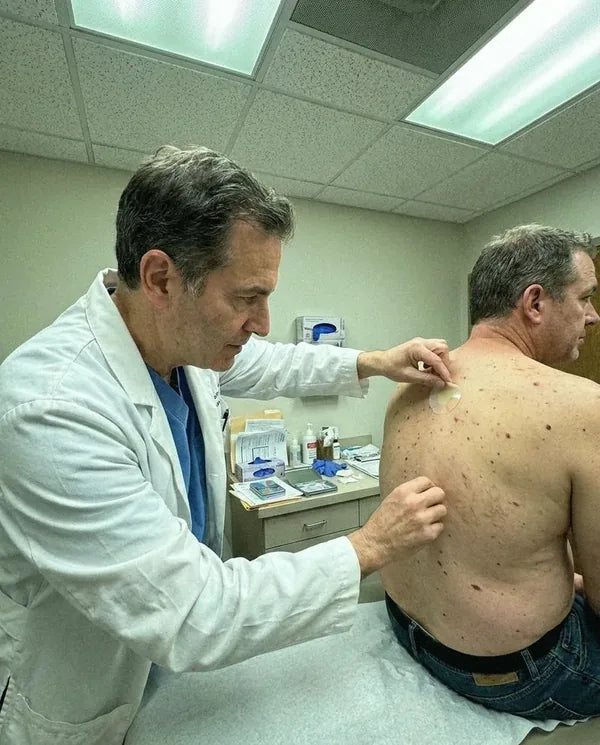 Dermatologist applying a Biosage XL patch to a patient's upper back